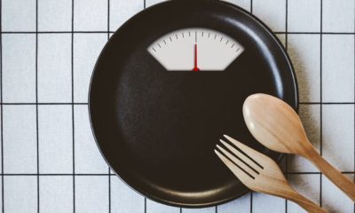 Weighing scale plate with wooden pork and spoon | Why Do Diets Fail? Myths Debunked | Featured