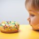 little kid staring on a donut | STUDY: Brain Differences in Kids May be Tied to Obesity | featured