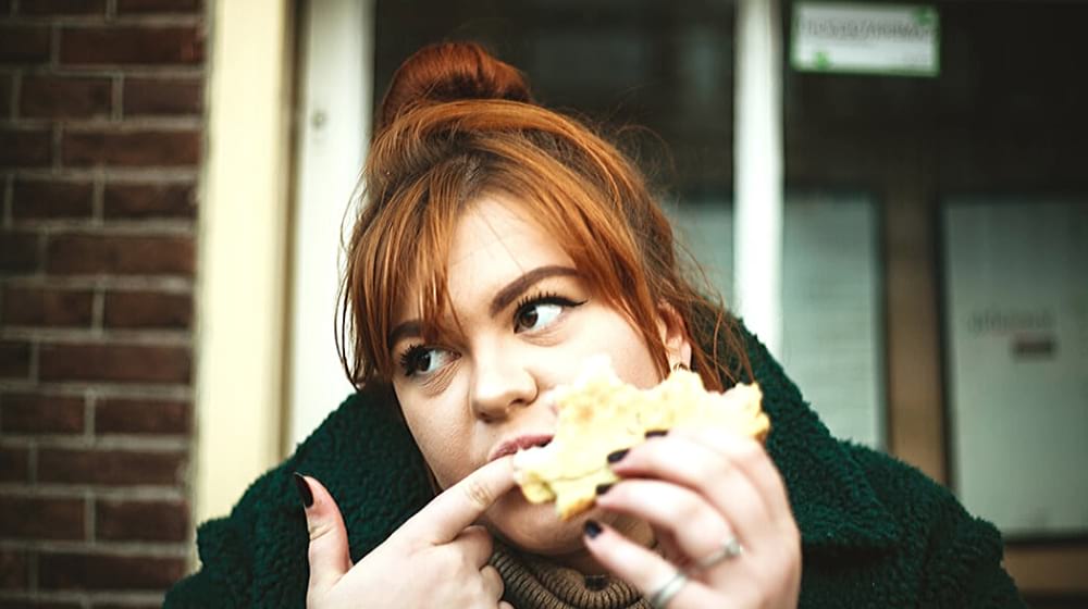 woman enjoying her sandwich | Myths to Weight Loss Everyone Should Know 