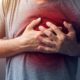man holding his chest | Warning Signs of a Heart Attack [Men vs. Women] | FEatured