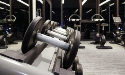 Dumbbells in the gym | Dumbbells on the steel rack in the gym and modern fitness center | Featured