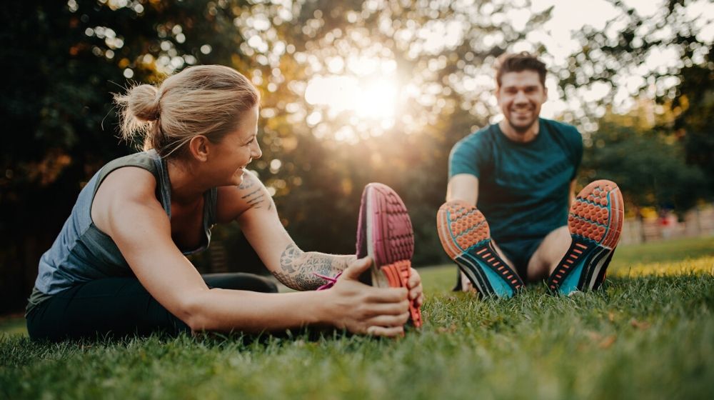 couple stretching | 6 Resolution Ideas for a New You in 2020 | Featured