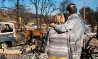 man and wife looking at their burned house | Natural Disasters: 5 Emergency Preparedness Tips for Seniors | Featured