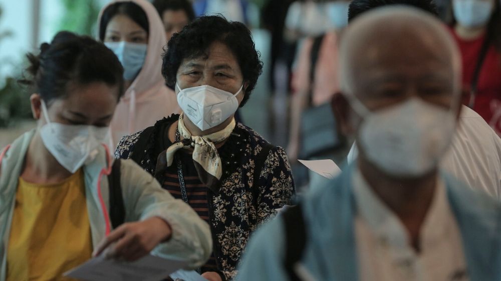 tourist in Wuhan wearing face mask | WHO: Coronavirus Declared Global Health Emergency | Featured