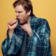 coughing and sick man | Young Sick Guy Wrapped in Checkered Plaid Coughing | Featured