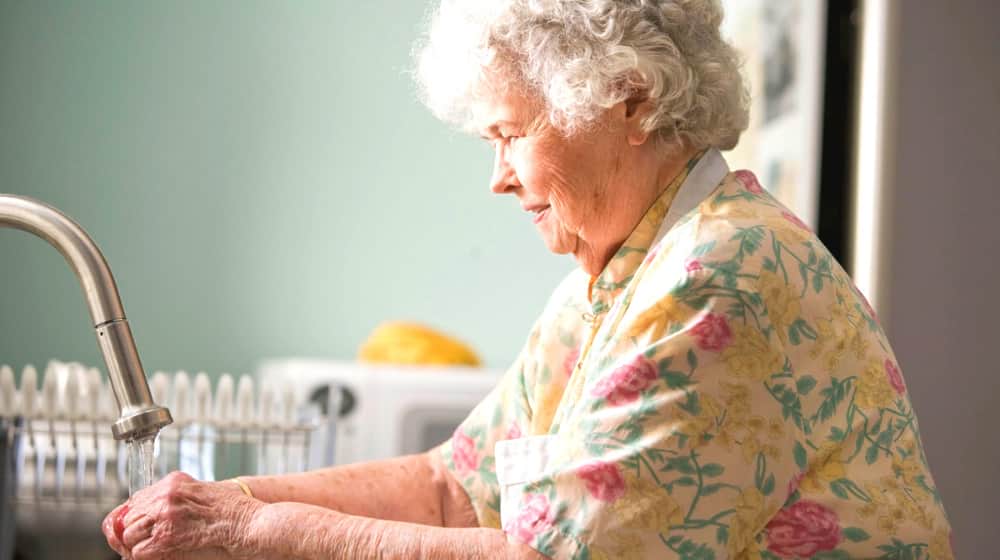 Old woman washing glass | WebMD Health Services Launches New Custom Health Plans for Senior Members | Featured 