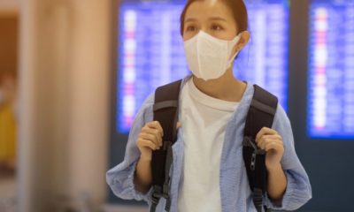 Asian woman on face mask | Quarantine Cruises Half Off: Coronavirus Effect on Travel Industry | Featured