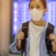 Asian woman on face mask | Quarantine Cruises Half Off: Coronavirus Effect on Travel Industry | Featured