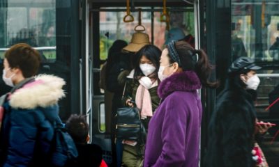 people going out of the bus | China Counters Economic Fallout from Coronavirus | Featured