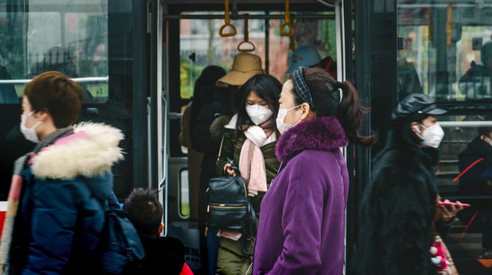 people going out of the bus | China Counters Economic Fallout from Coronavirus | Featured
