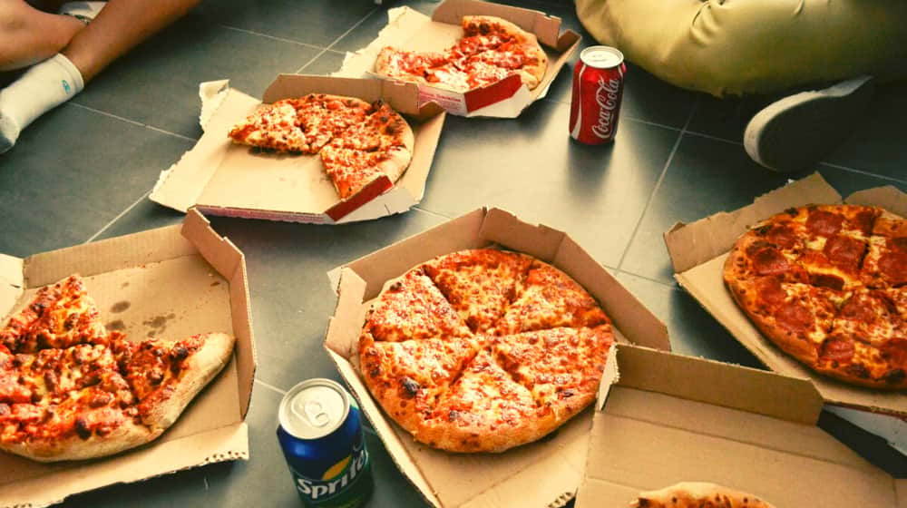 boxes of pizzas with cola | STUDY: Football Fans to Scoff 11,000 Calories Each on Superbowl Sunday 