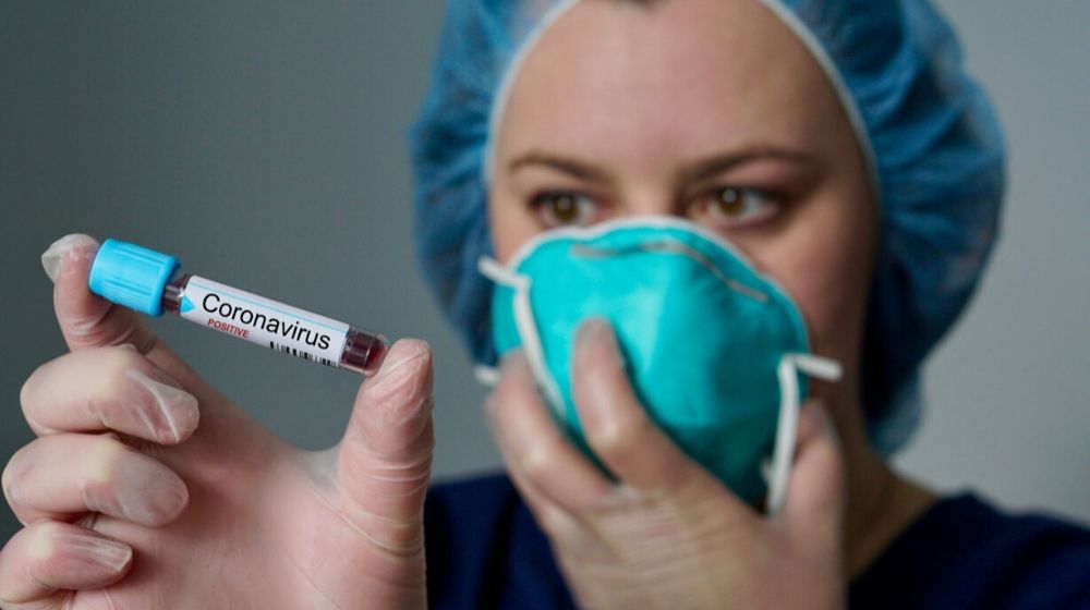 nurse holding a blood test for coronavirus | American Coronavirus Evacuees Being Held in California and Canada | Featured