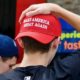 Two young men wearing Make America Great Again | Anonymous Group Releases Pigeons in MAGA Hats During Democratic Debate | Featured