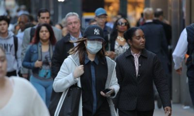 asian woman wearing mask on Manhattan street | The U.S. Is Now the Leader in Coronavirus Cases; Surpasses China and Italy | Featured