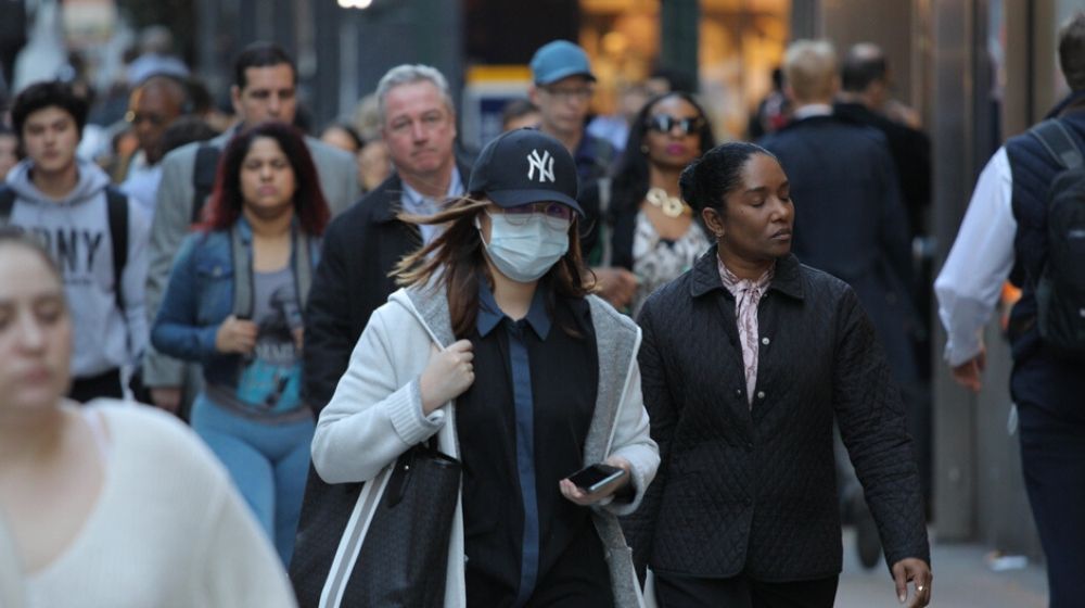asian woman wearing mask on Manhattan street | The U.S. Is Now the Leader in Coronavirus Cases; Surpasses China and Italy | Featured