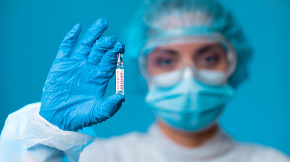doctor holding a covid-19 vaccine | Coronavirus: How Soon Will a Vaccine Be Ready? | Featured