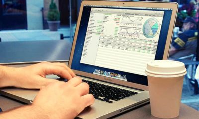 Checking stock market in a coffee shop | Will This Be Worse than 2008? | Featured