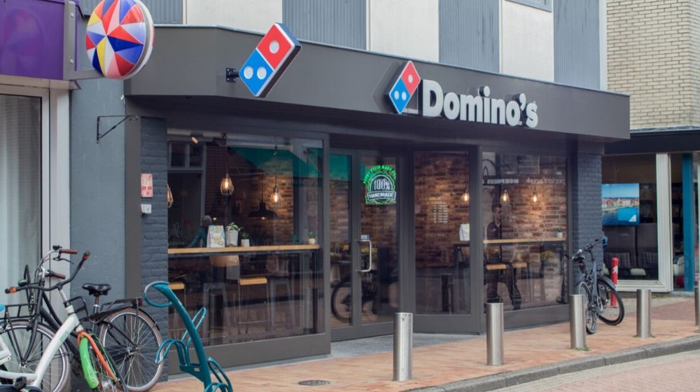 Dominos Pizza shop | Domino’s Pizza Plans to Hire 10,000 Employees to Meet Increasing Demands From Coronavirus | Featured