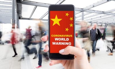 smartphone with blurred people at the background | How to Effectively Clean your Home or Business to Help Stop Coronavirus | Featured
