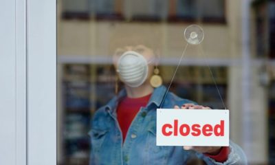 woman closing the shop | New York, New Jersey, and Connecticut Close Bars, Movie Theaters, and Casinos to Limit the Spread of the Coronavirus | Featured