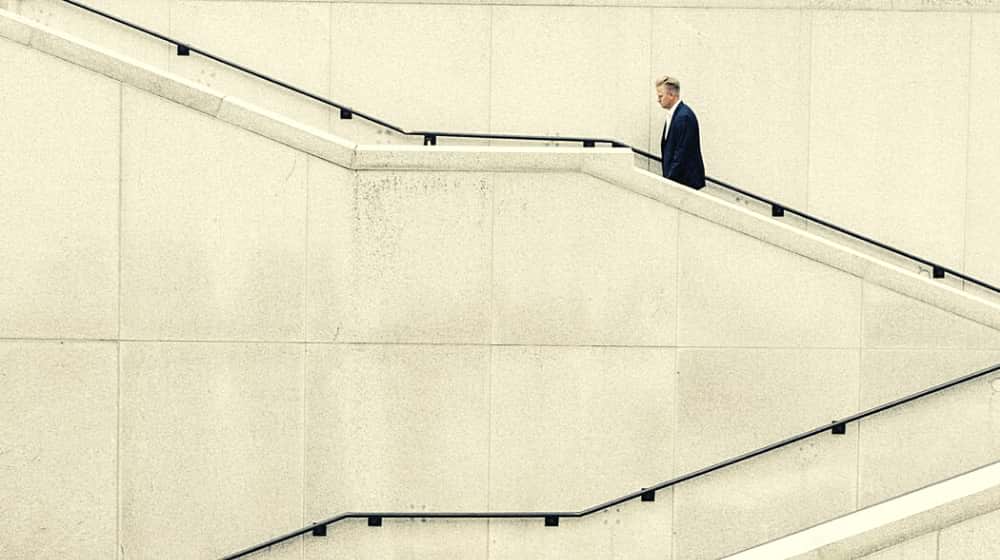 Man in suit going up stairs | $350B Small Business Lending Program Could Get Off to a Rocky Start | Featured