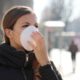 woman outside wearing a white face mask | The Head of the WHO Warns that 'The Worst' of the Coronavirus is 'Ahead of Us' | Featured