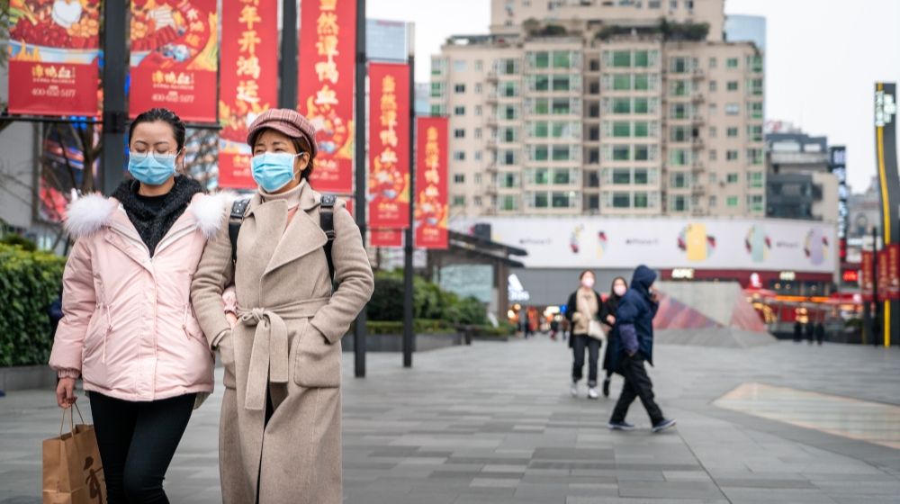 Chinese women walking on the street in China | China Coronavirus Outbreak Isn’t Over Yet | Featured