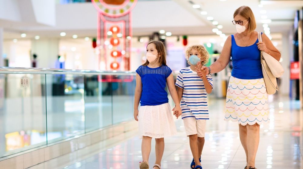 Mother and her two daughter inside a mall | Simon Property Group Plans to Reopen 49 Malls Amid Pandemic | Featured