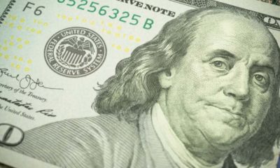 closeup of a dollar bill | Large Public Companies Must Return Federal Loans | Featured