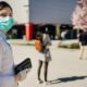 shopper wearing mask | Some Countries and US States Move to Ease Virus Lockdowns | Featured
