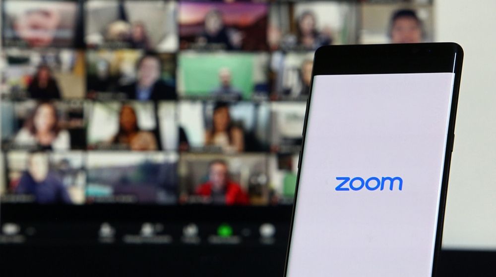 Zoom via smartphone | Zoom Sued By Pole Dancing Instructor After “Uninvited Men” Hacked Her Online Classes | Featured