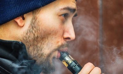 Man using a vape | House Oversight Committee Urges FDA to “Clear the Market” of E-Cigarettes Following Coronavirus Concerns | Featured