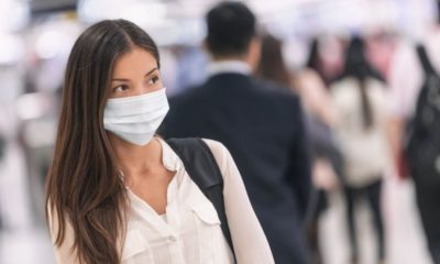 Asian woman traveling wearing a mask | Laredo, Texas Requires Residents to Wear Masks or Pay $1,000 Fine | Featured