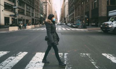 woman crossing a street | Study Suggests Millions of New Yorkers Infected | Featured