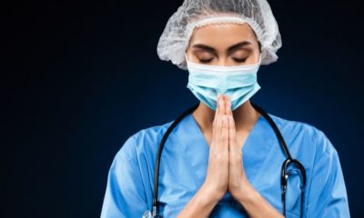 young doctor earnestly praying | Medical Staff Pray on Rooftops Amid the Coronavirus Pandemic | Featured