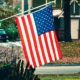 American flag raised outside a home | America Rises Up Against Lockdown | Featured
