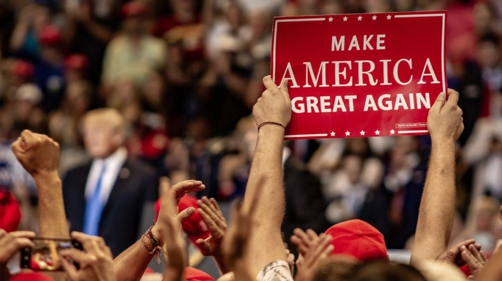 A Fan Holds Up a "Make America Great Again" Sign While President Donald J. Trump Delivering a Speech | Everything You Need to Know About President Trump's Rally In Tulsa | Featured