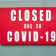 Closeup of Information Sign on The Metallic Window of The Store Front | COVID-19 Pandemic Extremely Affected Black Business Owners | Featured