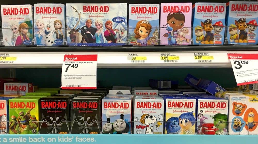 Department Store shelf with Boxes of Johnson and Johnson Brand with Cartoon Characters | Band-Aid Commits to Launching Bandages in Various Shades | Featured