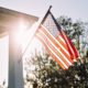 Front side of Typical American Porch Colonial House with American Flag | On Flag Day, Debate over Respect for 'Old Glory' Still Waves | Featured