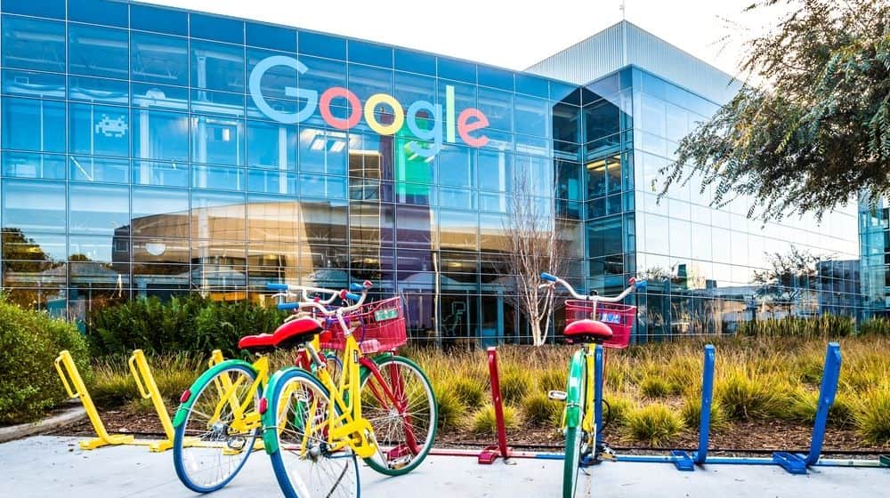 Google Headquarters with Bikes on Foreground | Google Announces It Will Pay News Publishers for “High-Quality Content” | Featured