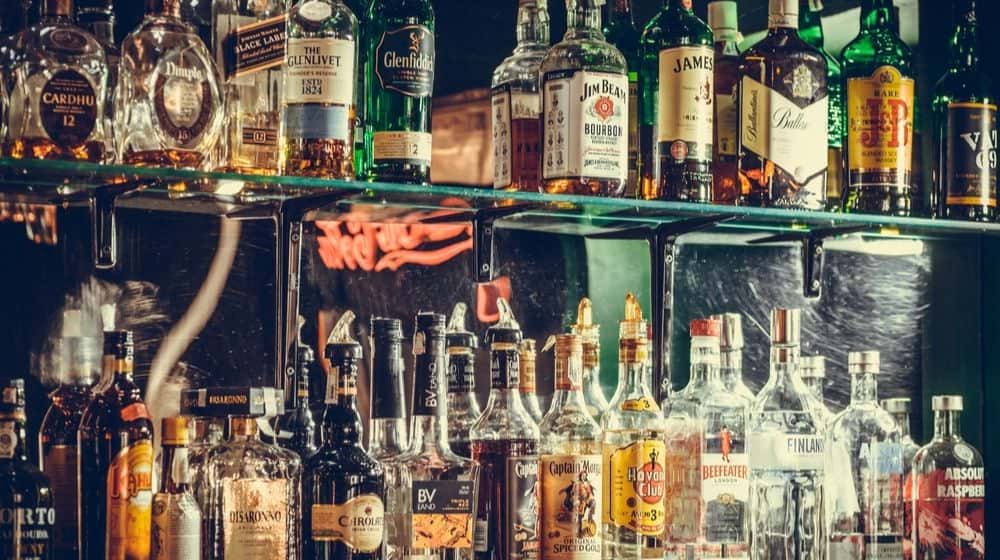 Image of Various Alcohol Bottles in a Pub in Bucharest, Romania | Alcohol Sales Spiked During COVID-19 Pandemic | Featured