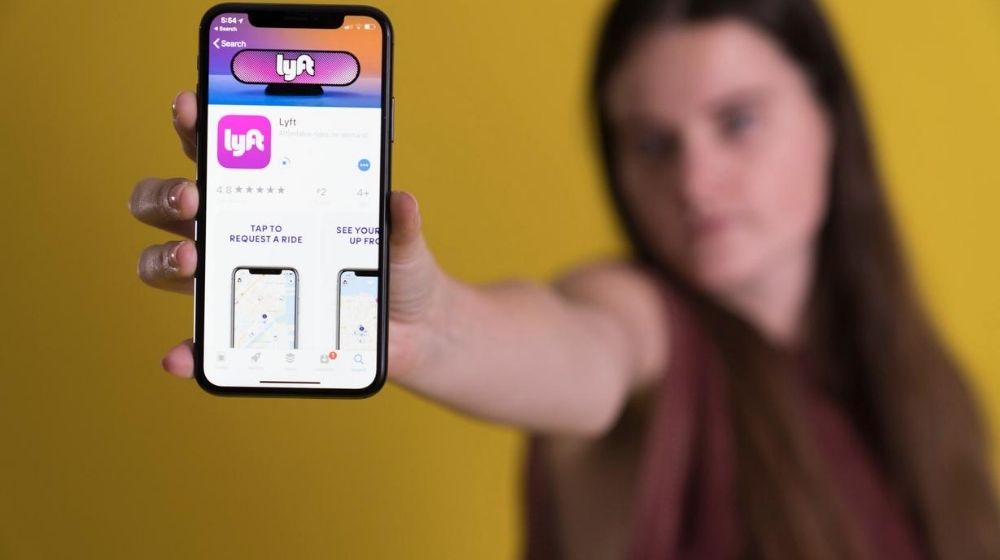Lyft app on smartphone | Lyft Commits to Switching to Electric Vehicles by 2030 | Featured