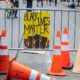 Black Lives Matter sign held at Protest on Streets | Seattle Occupied by Protesters, Closes East Precinct and City Streets | Featured