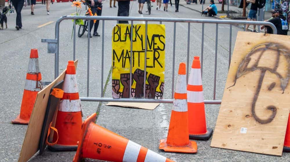 Black Lives Matter sign held at Protest on Streets | Seattle Occupied by Protesters, Closes East Precinct and City Streets | Featured