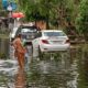 Woman Carrying Drinking Water through Water logged | Mumbai Spared, But Heavy Storms Ahead in 2020 | Featured