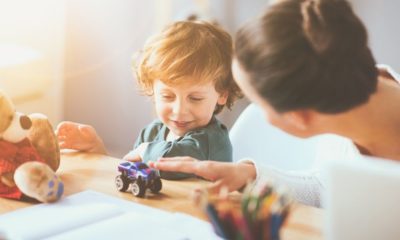 Delighted Young Thoughtful Mother Playing with Her Little Child Using Toys | Parents Worry About Childcare Costs After Pandemic, According to Survey | Featured
