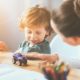 Delighted Young Thoughtful Mother Playing with Her Little Child Using Toys | Parents Worry About Childcare Costs After Pandemic, According to Survey | Featured