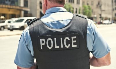 A Chicago City Policeman Standing on the Road on a Sunny Day | Michigan Police Officer Saves 3-Week-Old Baby from Choking | Featured