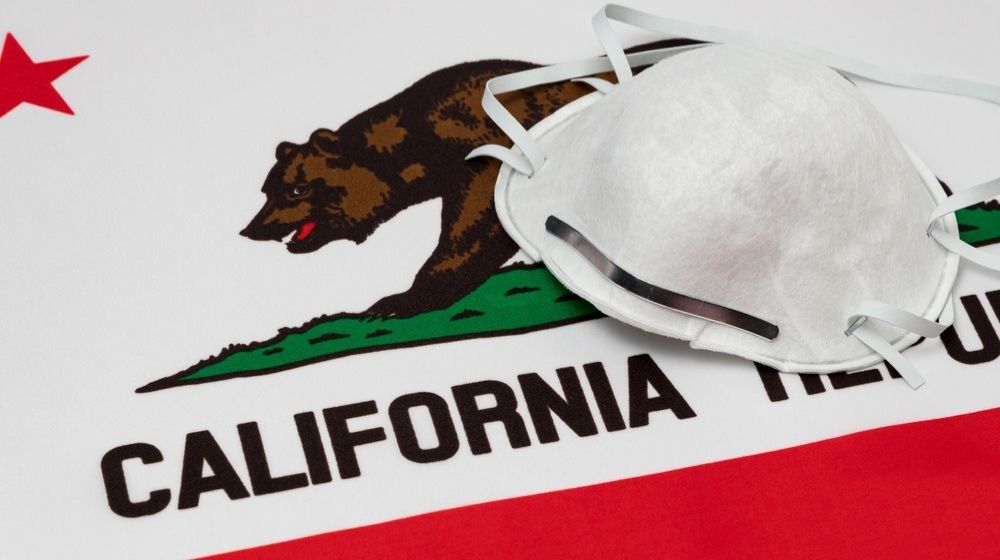 California State Flag and N95 Face Mask | California Surpasses New York as State with Highest Number of Coronavirus Cases | Featured